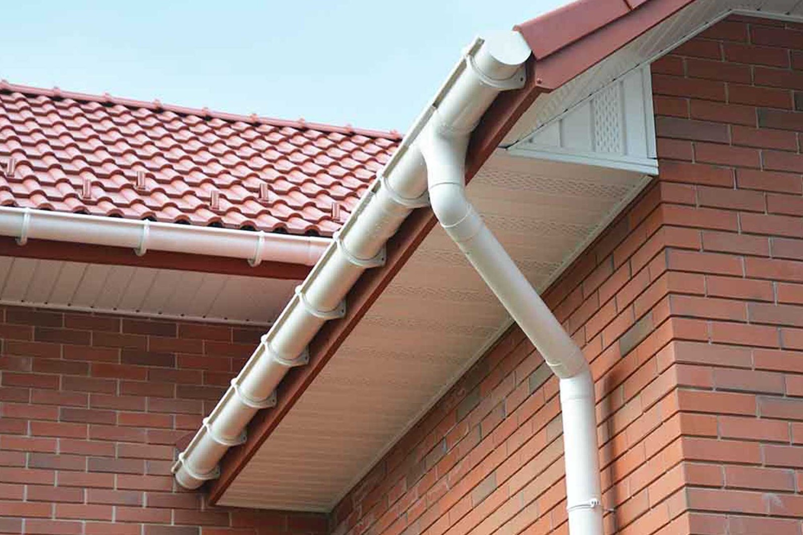 White fascia, soffit and guttering beneath a red tiled roof