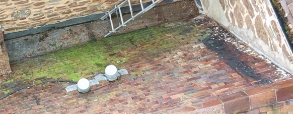 Lead valley beside the roof tiles and roof-to-wall junction