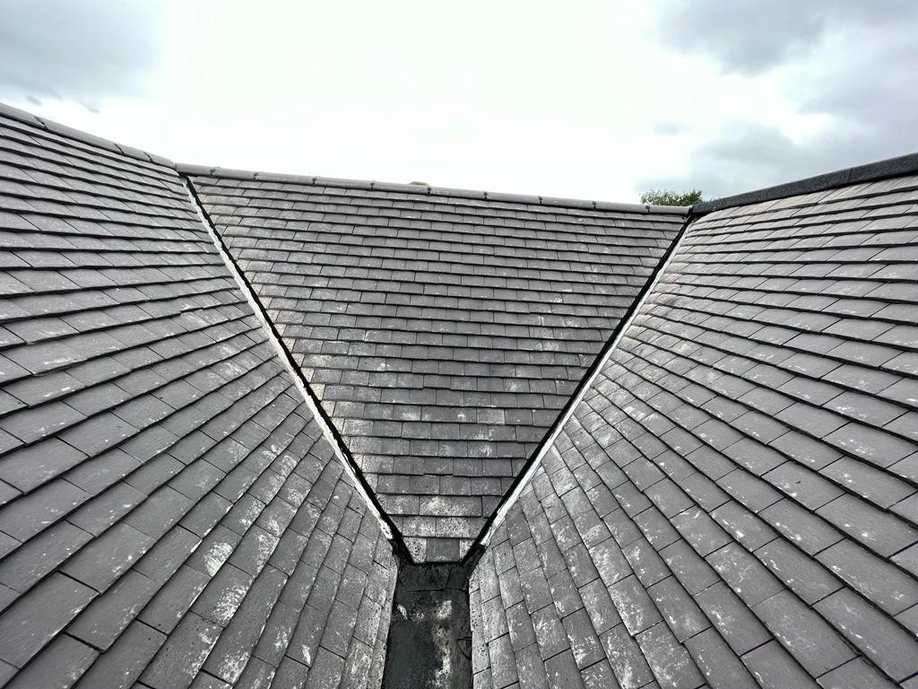 Three slate roof slopes meeting at a lead-lined valley