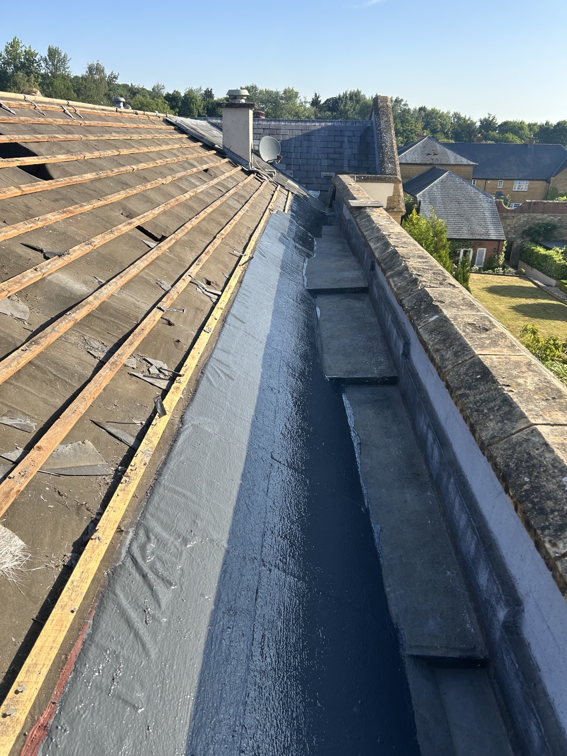 Roof and parapet junction during waterproofing work